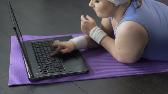 Overweight Girl Lying in Front of Laptop, Typing Angrily, Feedback to Comments