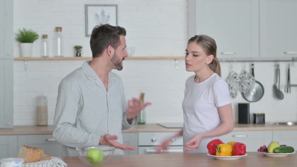 Young Woman Arguing with Man in Kitchen