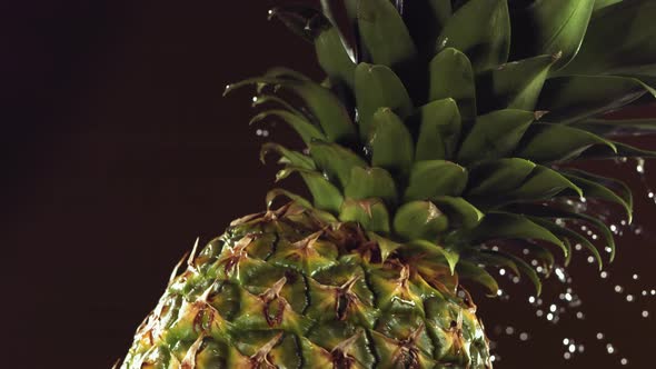 Super Slow Motion Water Drips on Rotating Pineapple