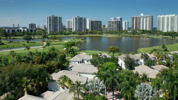 Sunny Summer Day in Miami.  Aerial White Cottages at the Green Golf Course