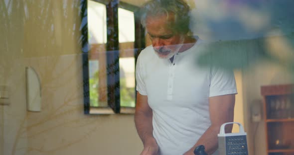 Senior man chopping vegetable in kitchen 4k