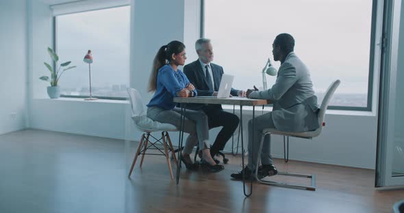 African man candidate communicating with job interviewers