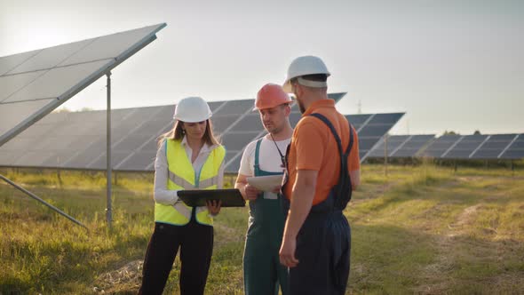 Three Solar Energy Specialists at a Solar Power Facility