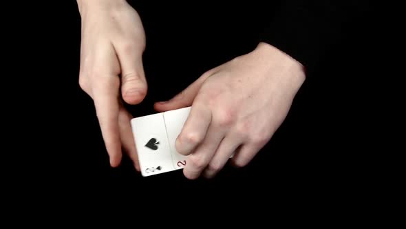 Playing Cards Being Changing, on a Black Surface By Magician