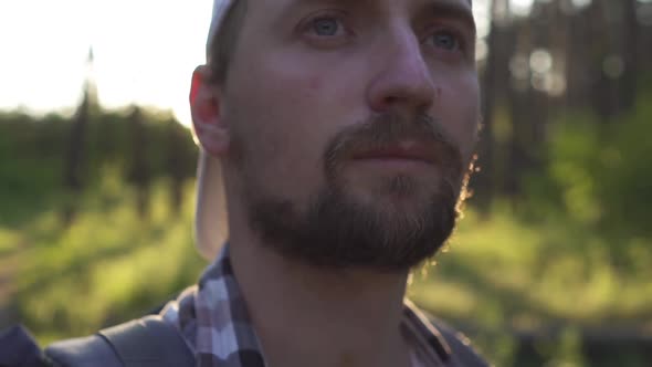 A Young Man Walks in the Woods