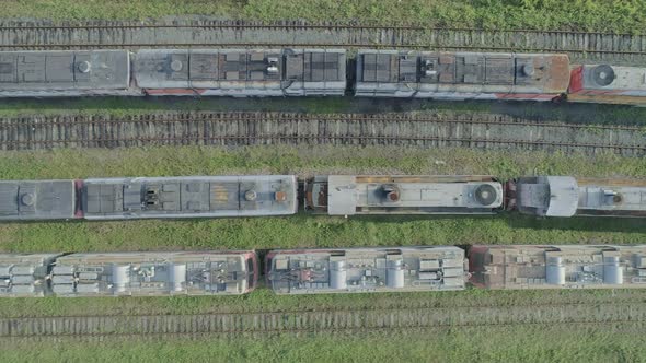Aerial Top Down Shot of an Abandoned Rusty Locomotives and Old Railways