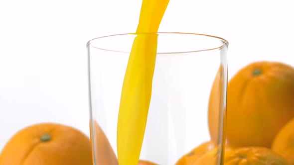 Pouring orange juice into glass, Slow Motion alt
