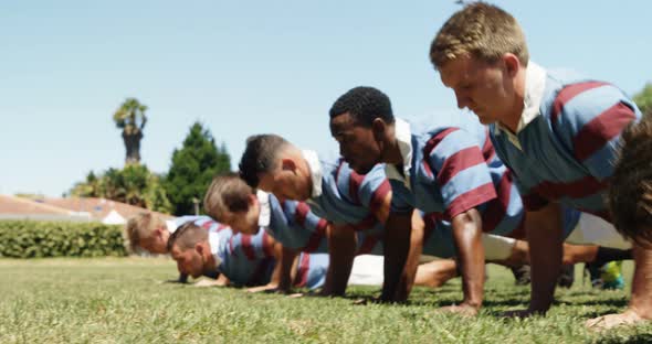 Rugby players doing push ups in the field 4K