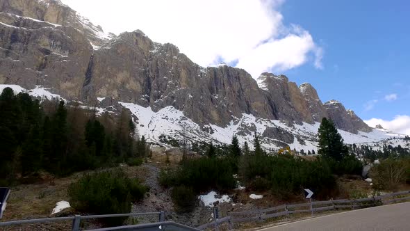 View from a driving car on the winding roads in the mountains, Dolomites, Alps