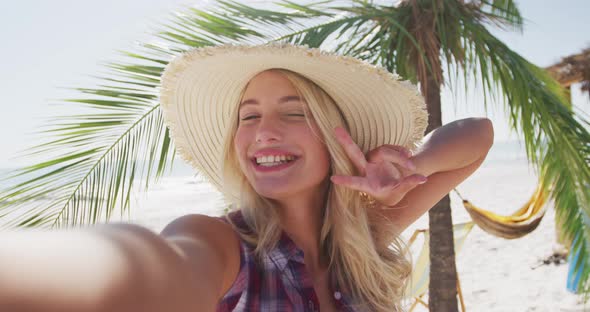 Portrait of a Caucasian woman taking a selfie on the beach