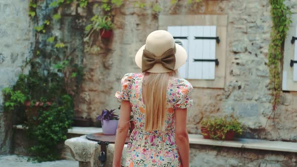 Back View of Woman in Floppy Sun Hat with Ribbon Bow