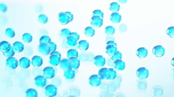 Super Slow Motion Shot of Blue Hydrogel Balls Bouncing on Glass at 1000Fps