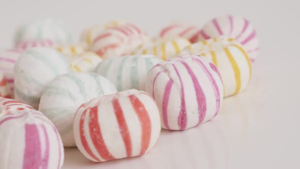 Slow panning on striped sugar bonbons close-up 4K footage alt