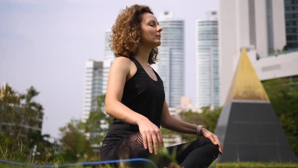 Young Female Doing Yoga And Meditation In Park