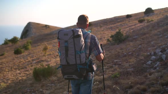 Following Shot of Athletic Man Climbing Mountain Hike Travel During Backpack Hike Spbd