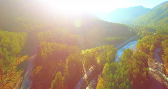 Mid Air Flight Over Fresh Mountain River and Meadow at Sunny Summer Morning