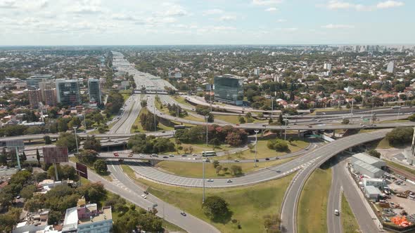 Aerial orbit shot of traffic driving on a highway interchange at daytime