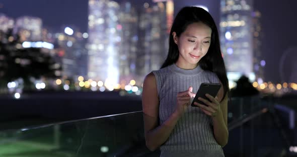 Woman use of mobile phone at night 