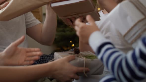 Family sharing the Christmas presents in bed. Shot with RED helium camera in 8K