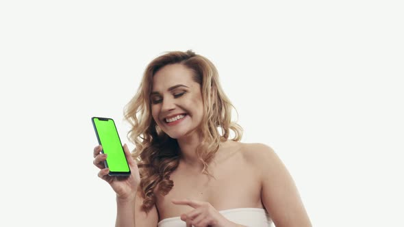 Happy Female Showing Green Screen Smartphone on White Background