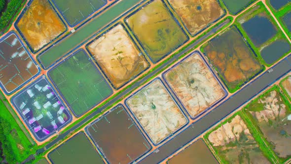 An aerial view over a drone flying over a large shrimp farm