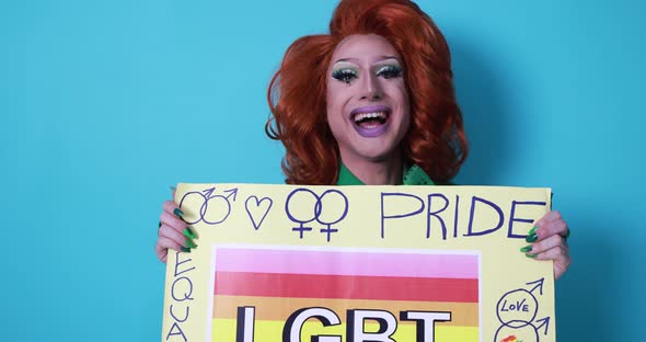 Happy drag queen holding gay pride banner - Lgbt concept