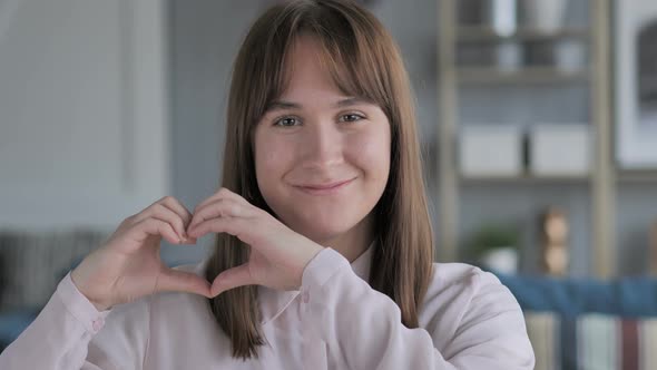 Handmade Heart Gesture by Young Girl in Love