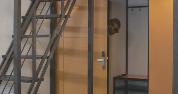 Positive African American Man Entering Room in Hotel with Luggage. Portrait of Handsome Young