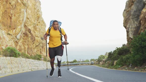 Sporty mixed race man with prosthetic leg hiking