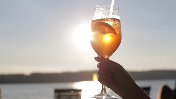 Female Blogger Takes Pictures of a Glass of Cocktail in a Cafe with Her Phone