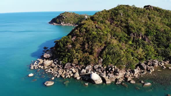 Calm Sea Near Tropical Volcanic Island. Drone View of Peaceful Water of Blue Sea Near Stony Shore