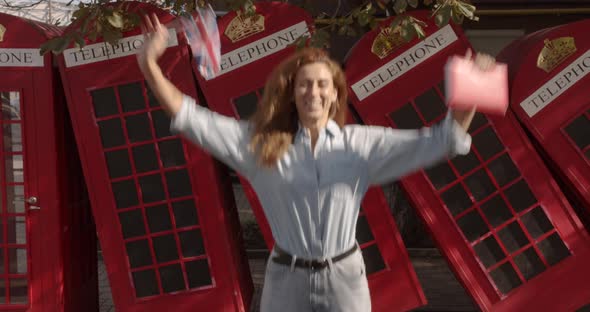 A Woman Holds a British Flag and a Book and Bounces with Them. Joy Fun. Education Abroad, Language