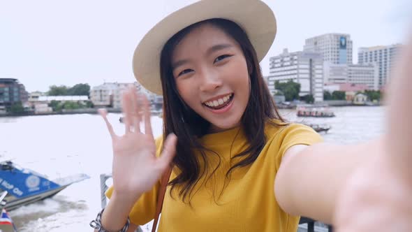 Beautiful Asian woman taking selfies on a smartphone.