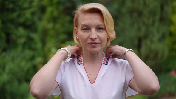 Front View Adult Woman in Traditional Ukrainian Shirt with Embroidery Looking at Camera Smiling