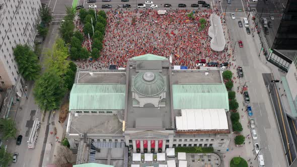 Lots of people gather at a Cancel Canada Day protest, aerial drone flyover. Native activists rally i