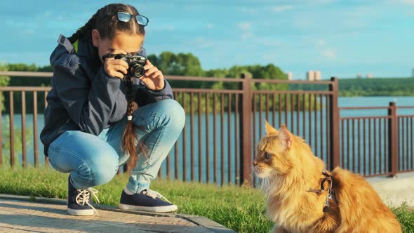 Girl Photographer Taking a Picture of His Pet, a Beautiful Cat.