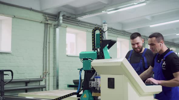 Mentor Trains an Intern in a Factory