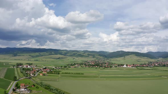 Aerial View Of Green Fields Near Houses Between Sansimion And Sanmartin Commune In Romania