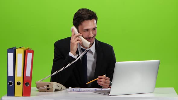 Man Talking on the Phone From His Office. Green Screen