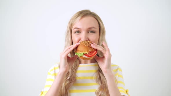 Closeup Of Woman Mouth Eating Vegan Burger