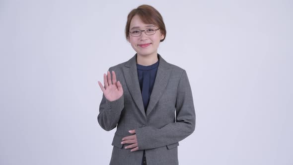 Young Happy Asian Businesswoman Waving Hand