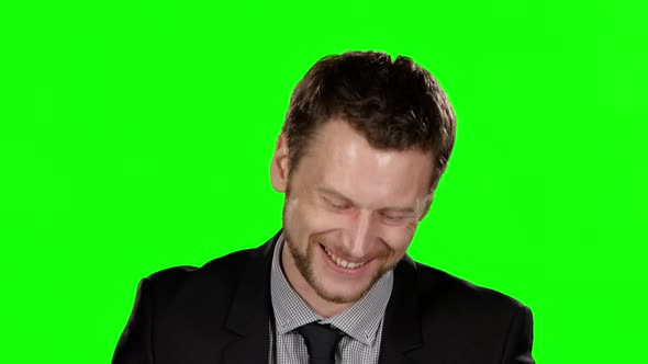 Smiling Young Man in Formal Suit Looking at the Camera. Green Screen