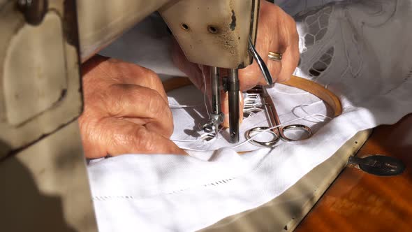 Old Woman is Working with a Sewing Machine