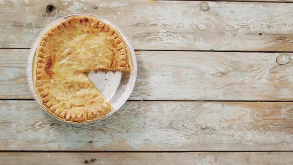 Video of pie seen from above on wooden background