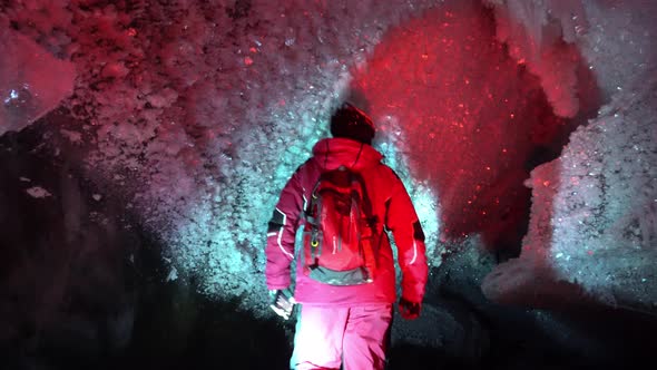 A Guy in an Ice Cave with a Lantern Light