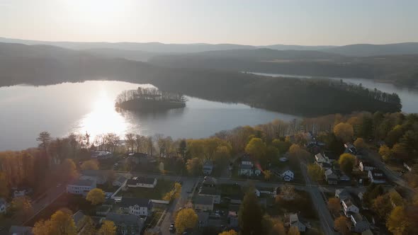 Aerial pan and push, in the sunny autumn sky featuring a beautiful suburban area during the fall tim