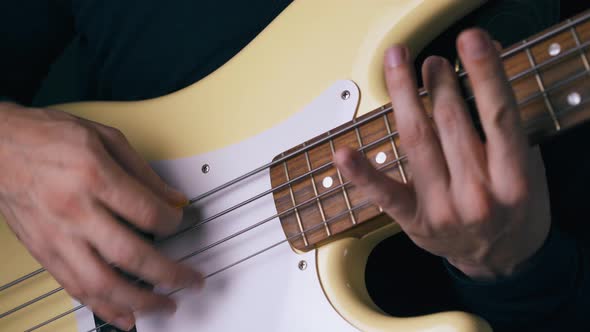 Funky Artist Hands Play Solo on Bass Guitar with Tricks