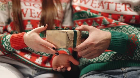 Men's Hands Give Different Box With a Gift to Woman