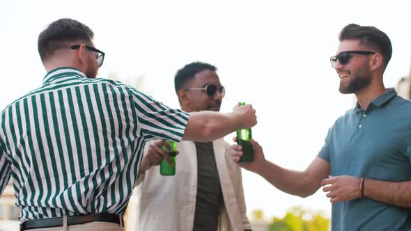 Happy Male Friends Drinking Beer at Rooftop Party