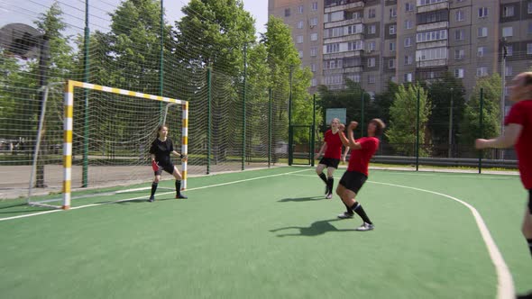 Female Soccer Player Hitting Ball with Head and Striking Goal